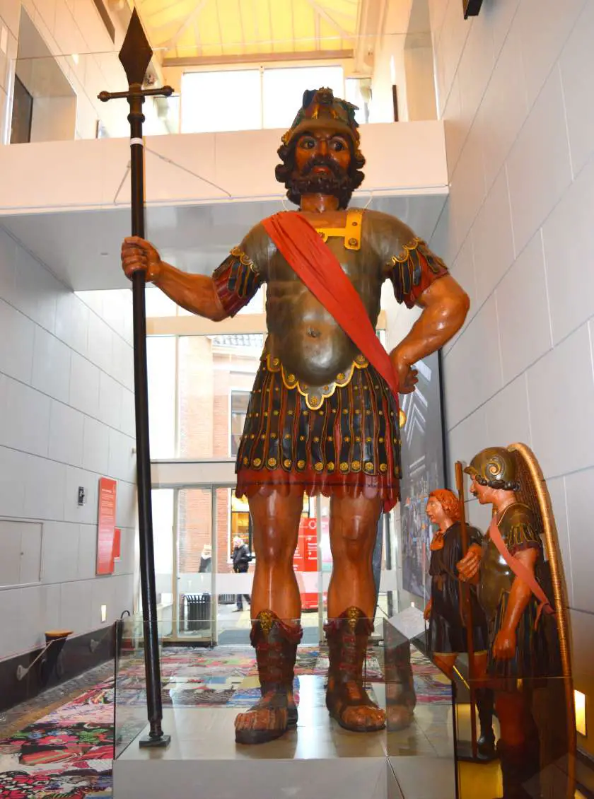 Large soldier holding a staff in Roman uniform statue in the Amsterdam Museum in Amsterdam