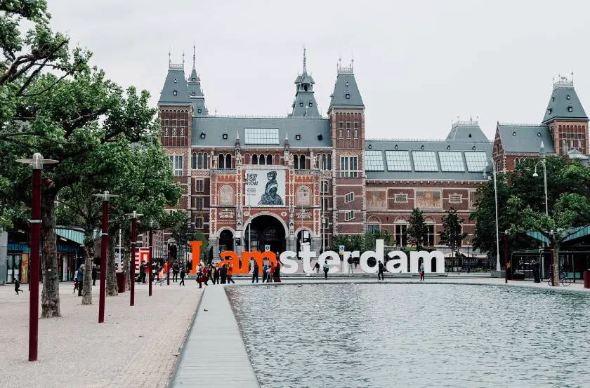Outside the Rijks Museum in Amsterdam with the Iamsterdam sign in the foreground