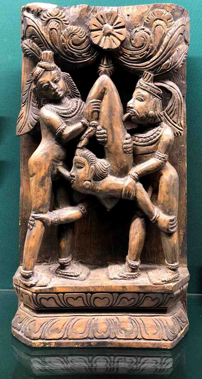Ancient medieval totem of three people in a sexual position in the Sex Museum in Amsterdam 