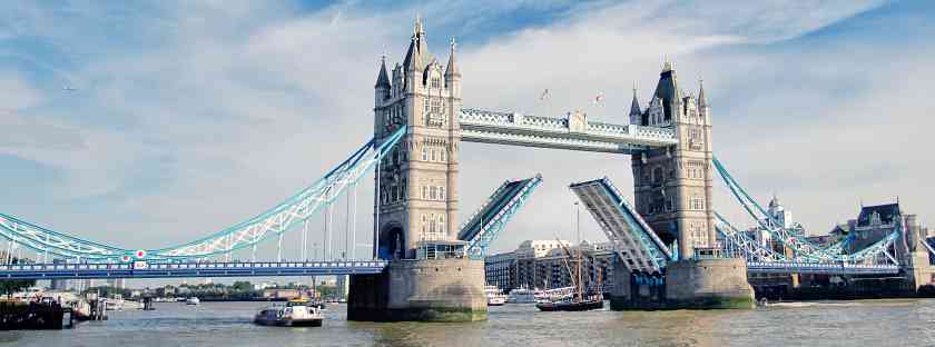 View of Tower Bridge in London with the bridge up to let ships go by on the Thames river