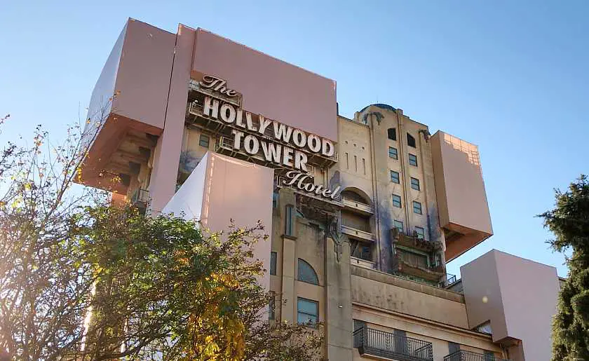 Outside the hollywood tower hotel ride at Disneyland Paris, a tall pink building with burnt out lifts