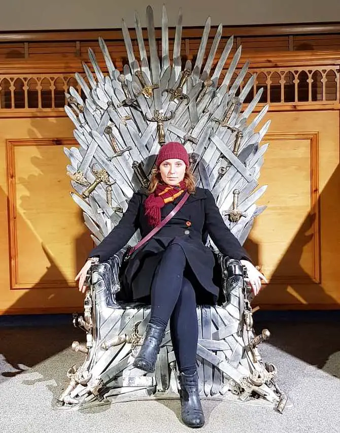Mel sat staring at the camera sat on the Iron Throne at Gracehill House