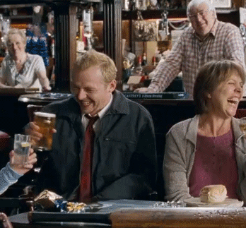 People saying cheers in a pub