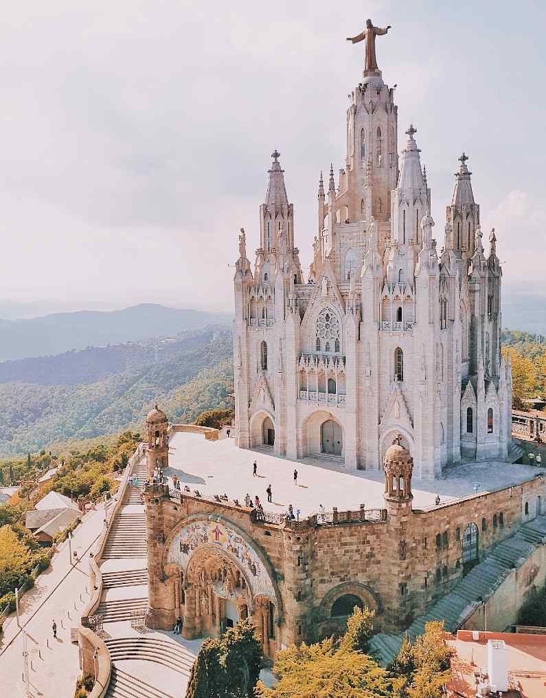 Grand church in Barcelona with a statue of Jesus Christ on top of it