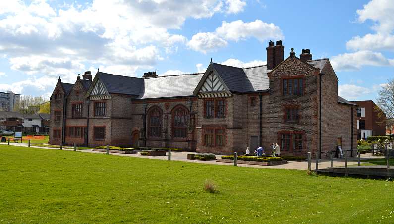 Ordsall Hall in Manchester - a Tudor building with a green lawn in front