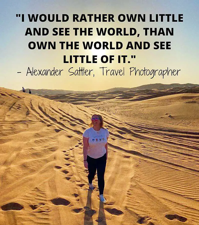Mel walking through the desert in Dubai with the quote: "I would rather own little and see the world than own the world and see little of it." ― Alexander Sattler, Travel Photographer