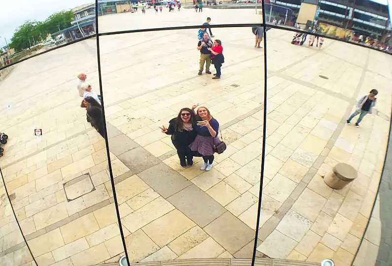Friends posing for a selfie in the Bristol planetarium - a giant mirrored ball