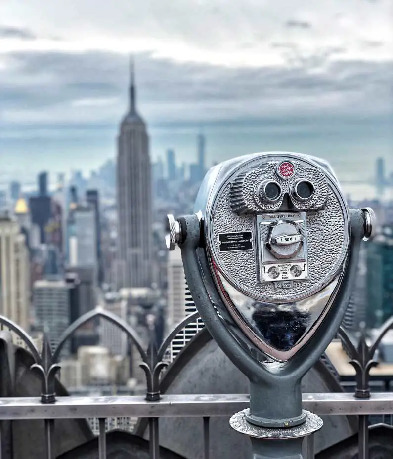 Observation deck at Top of the Rock with tower viewer (binoculars) and the Empire State Building in the background