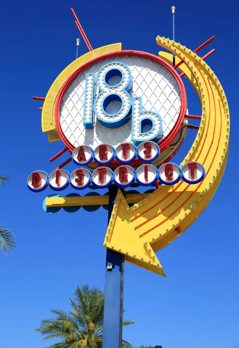 Yellow, blue and white neon sign during the day that says: "18b Arts District" in downtown Las Vegas