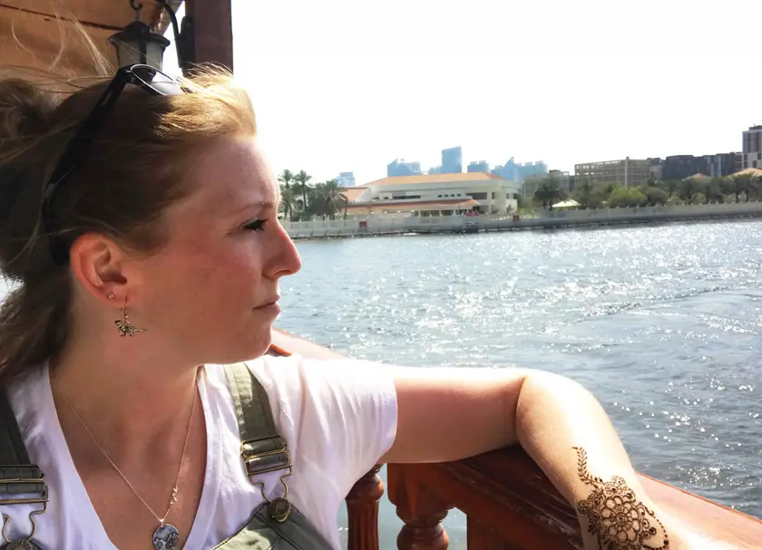 Mel from Footsteps on the Globe side on looking onto Dubai Creek from an open river boat window, Breaking up, backpacking and beginning again