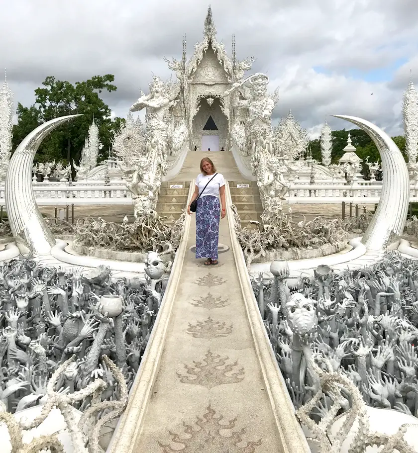 Mel from Footsteps on the Globe crossing the bridge to the Wat Rong Khun 'White Temple' in Chiang Rai in Thailand, Breaking up, backpacking and beginning again 
