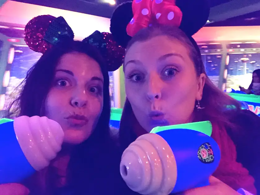 Mel from Footsteps on the Globe and her friend Tami holding up Buzz Light Year guns on the Buzz Lightyear ride at Disneyland Paris, Reasons to go to Disneyland Paris