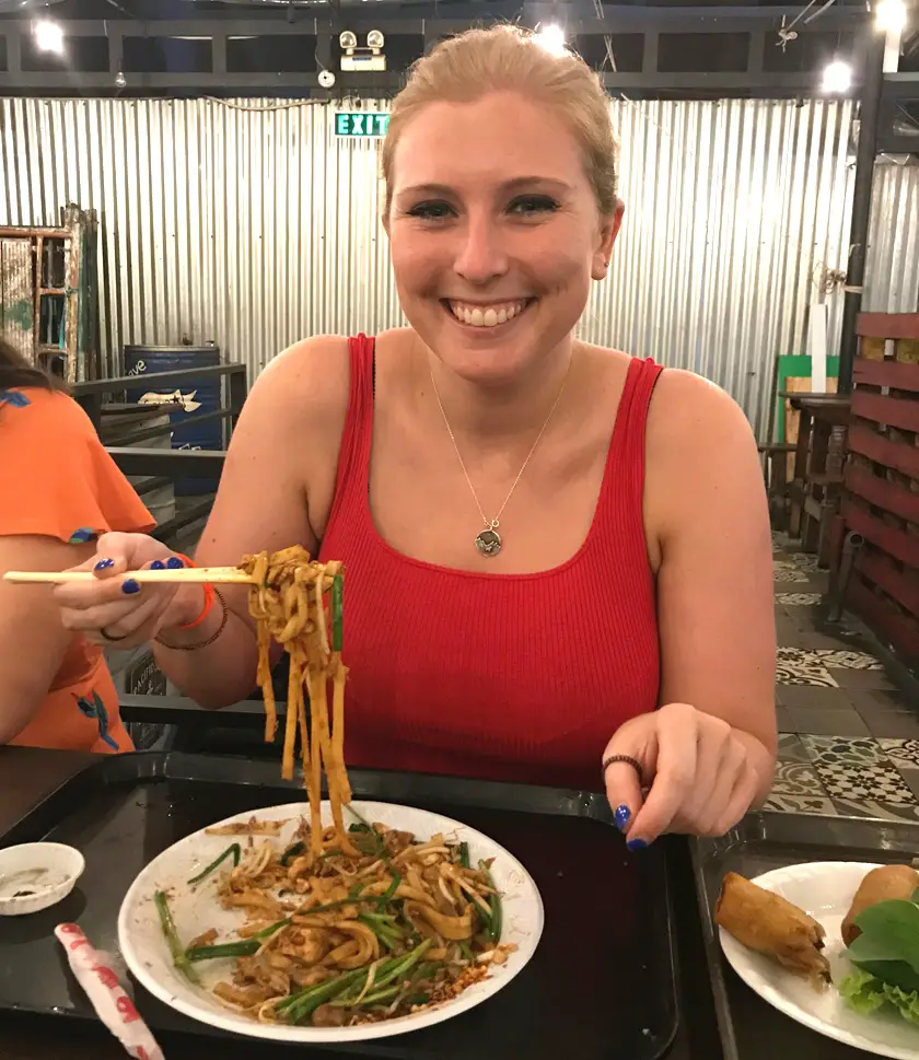 Mel from Footsteps on the Globe eating noodles at the Ben Thanh Food Market in Ho Chi Minh City in Vietnam