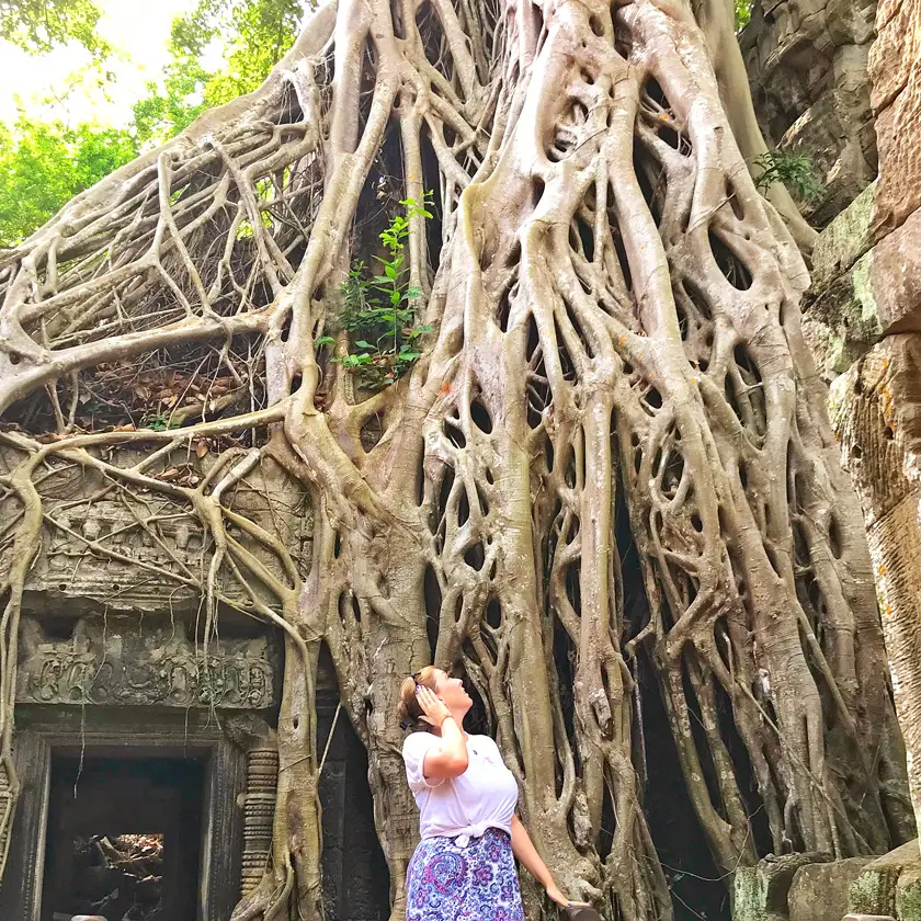 Mel from Footsteps on the Globe looking up at vines enveloping a temple where Tomb Raider was filmed.