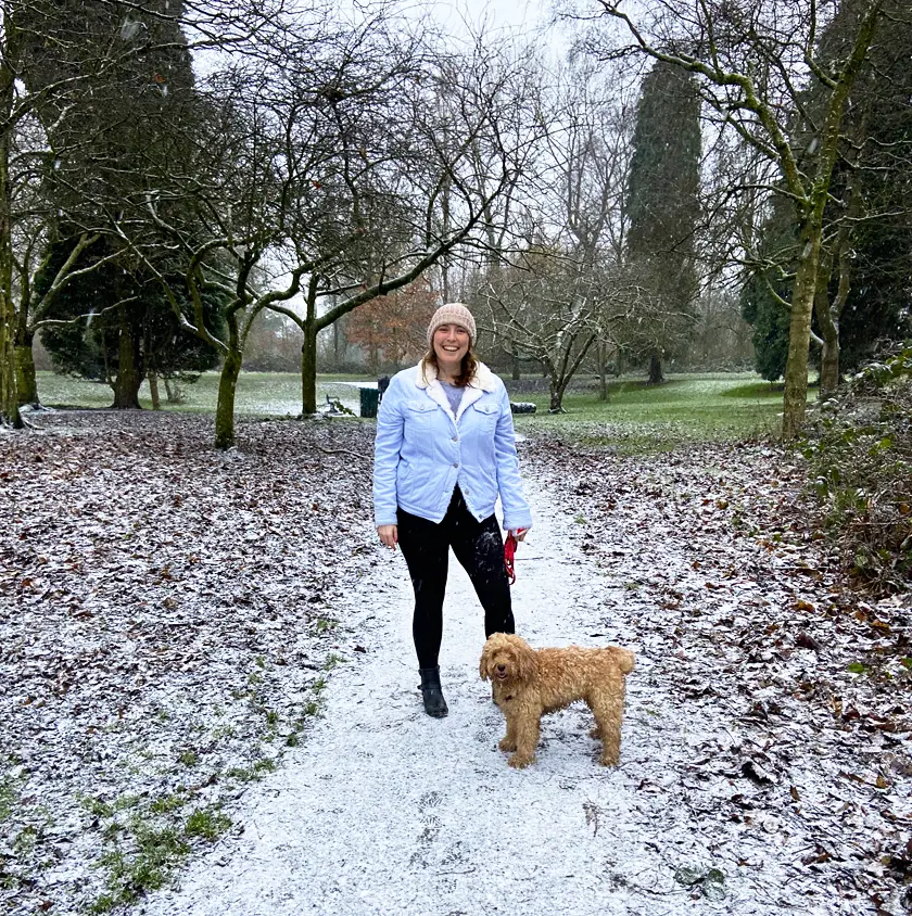 Mel taking Lilly the cockapoo for a walk in the park in the snow
