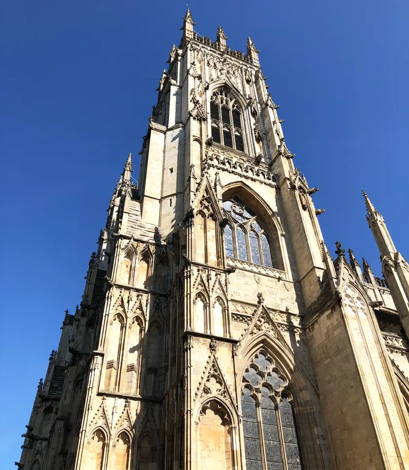 Outside York Minster, a grand cathedral against a blue sky in York, UK