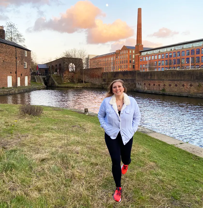 Mel walking by the canal in Ancoats Manchester at sunset