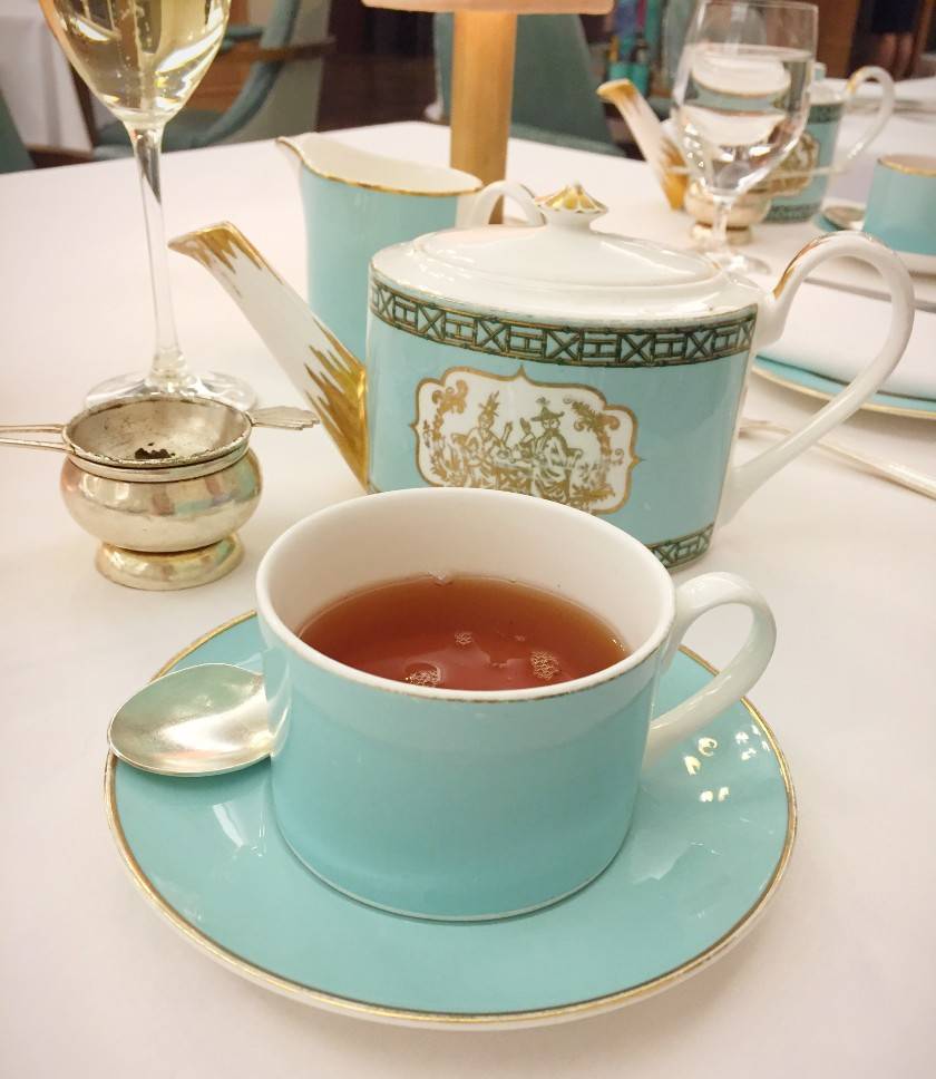 Close up of a cup of black tea served from a Fortnum and Mason green teapot