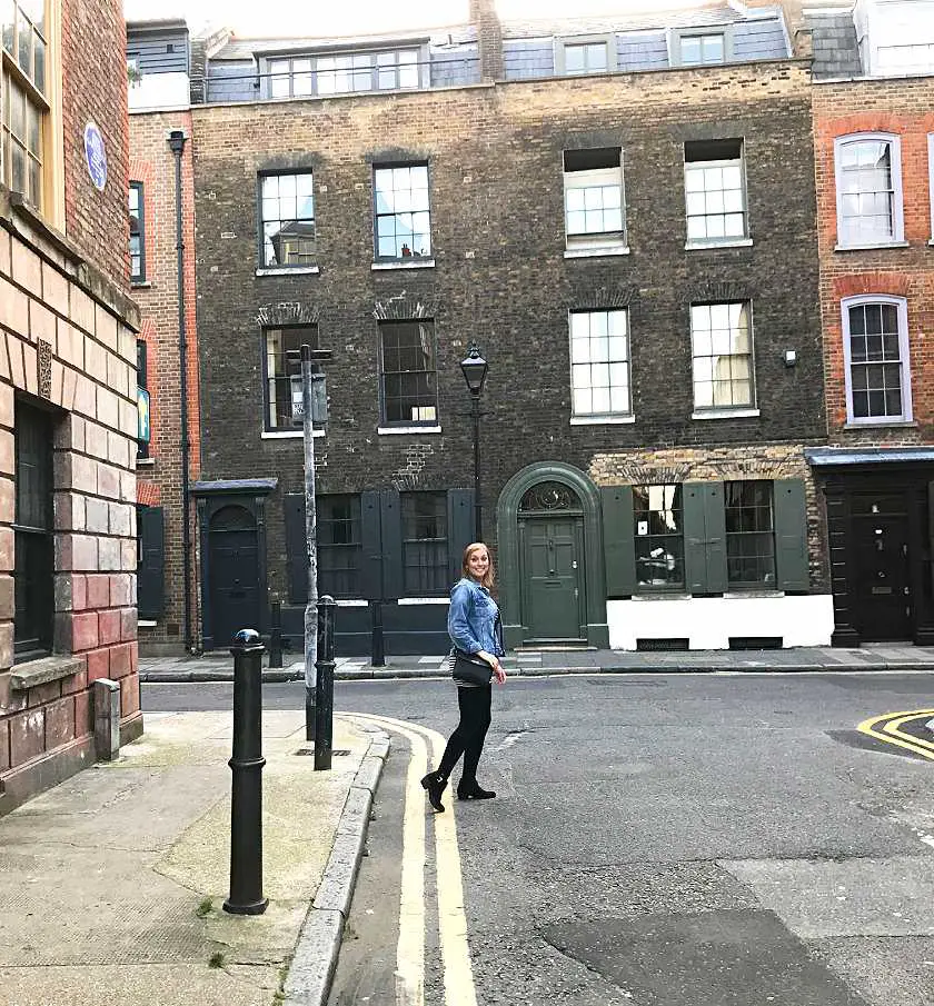 Mel walking down a cobbled street in Whitechapel, London where the Jack the Ripper murders took place