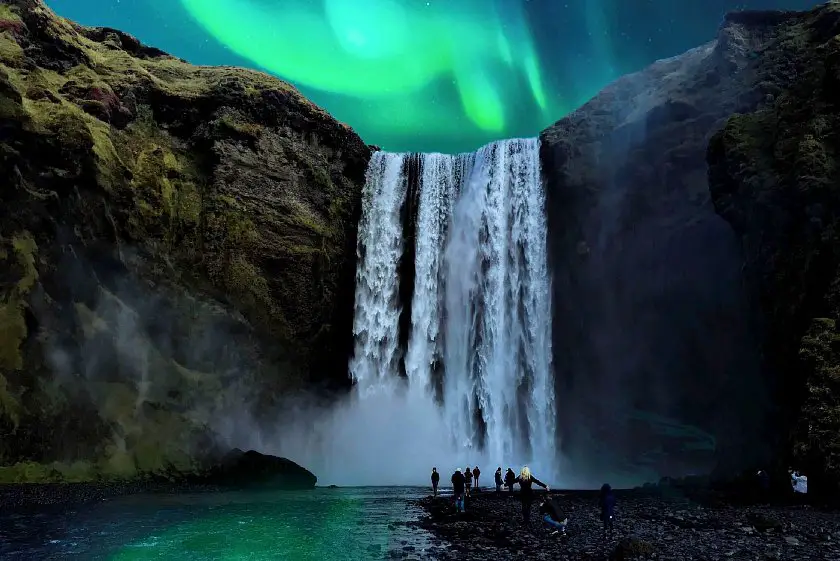 The Northern lights over a waterfall in Iceland