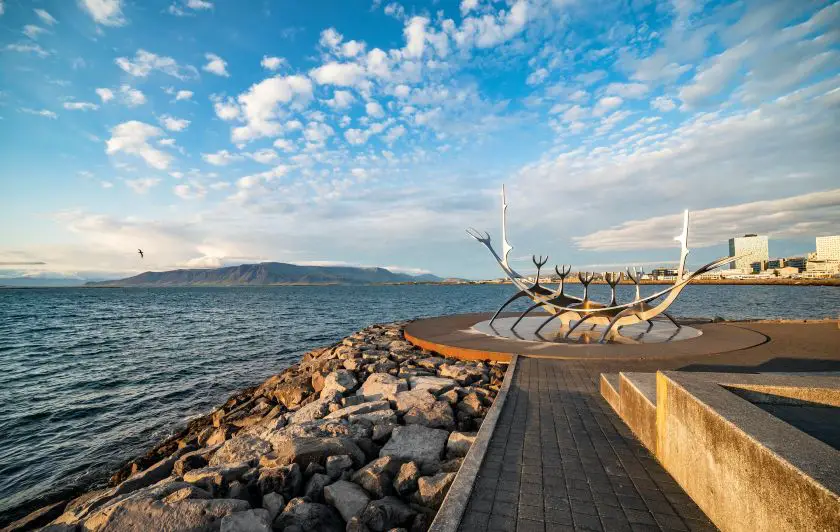 Reykjavik city centre with whale statute and mountains and water in the background