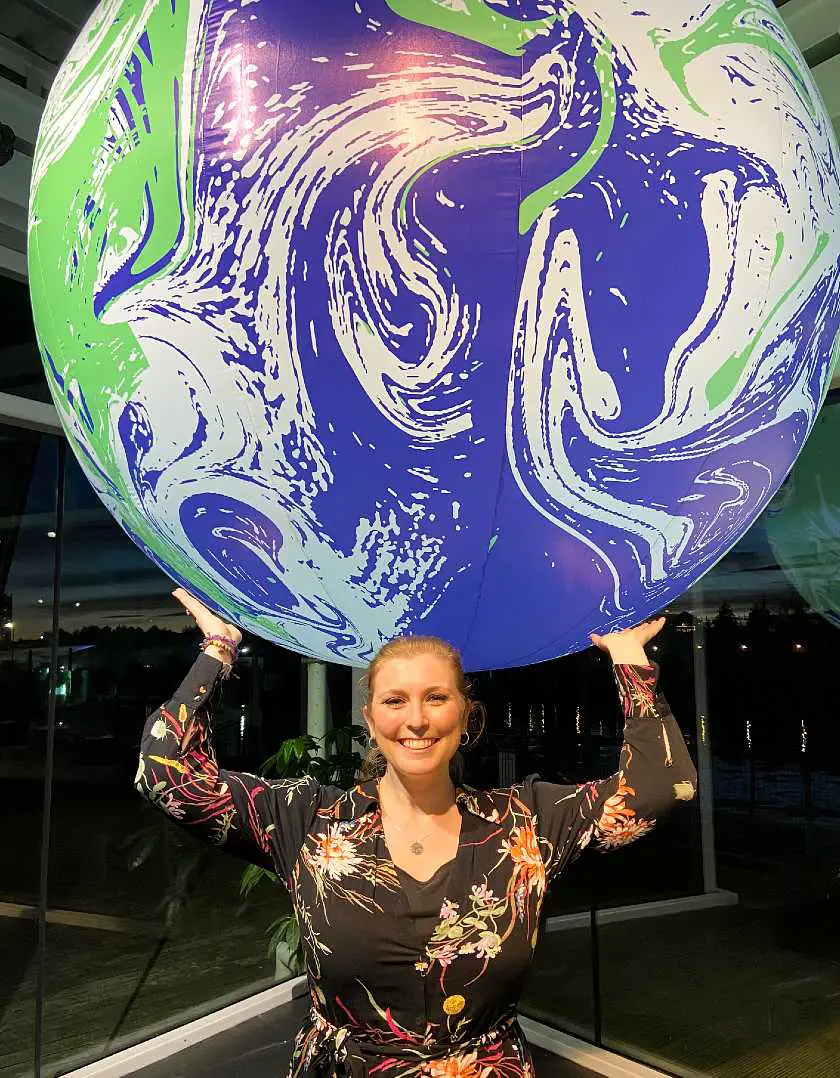 Mel at the Climate Change Conference pretending to hold up a large inflatable globe