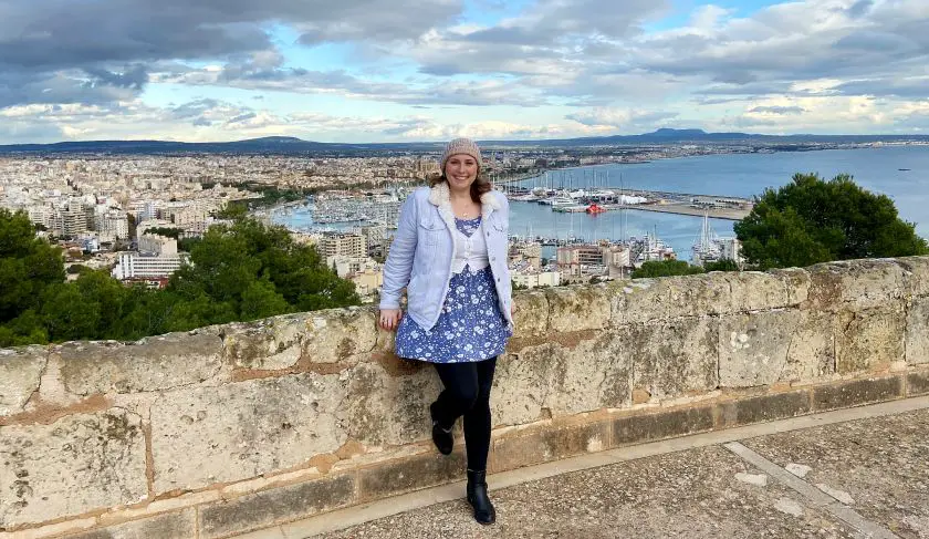 Mel posing against at the top of Palma Fort with Palma harbour in the background