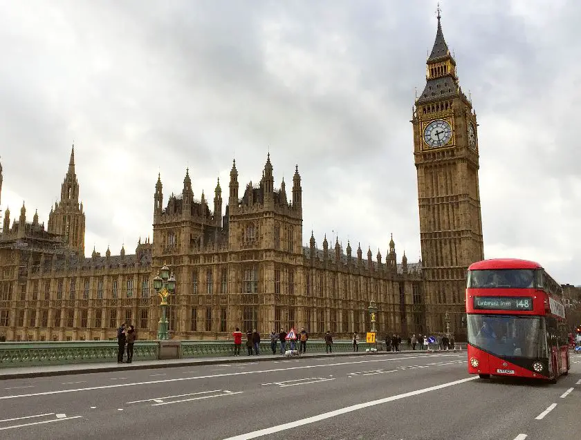 Houses of Parliament and red double decker bus from Westminster Bridge London 