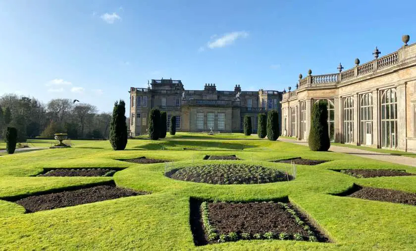 Manicured green lawns outside the side of Lyme Park House