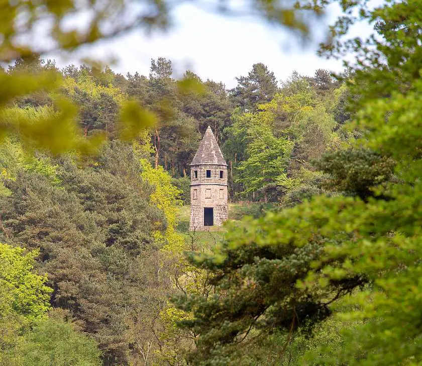 Mall lantern shaped building amongst trees at Lyme Park 