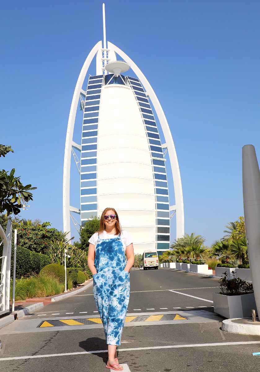 Mel stood in front of the Burj Al Arab wearing blue overalls