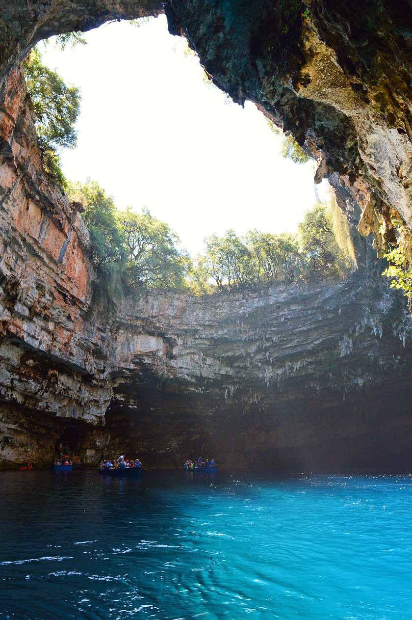 Melissani Lake in Kefalonia with boats on top of the water 