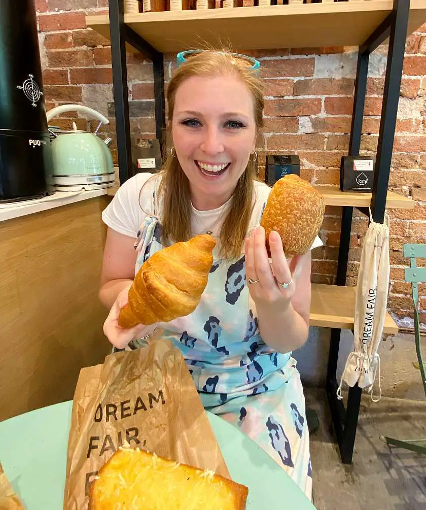 Mel holding croissants in Land and Monkeys bakery in Paris