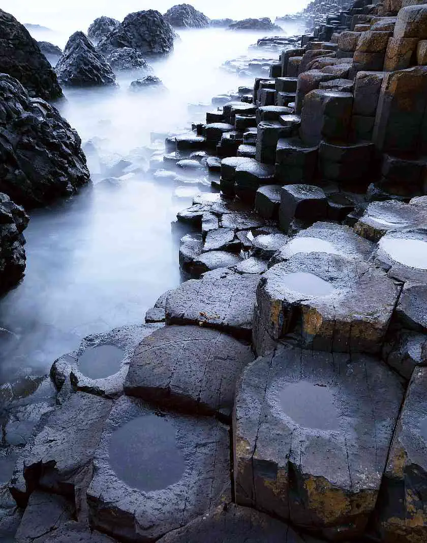 Hexagon-shaped stones at the Giant's Causeway up-close with white mist all around them