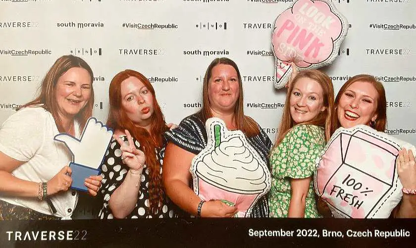 Mel and her blogger friends posing in a photo booth with props at Traverse's final night