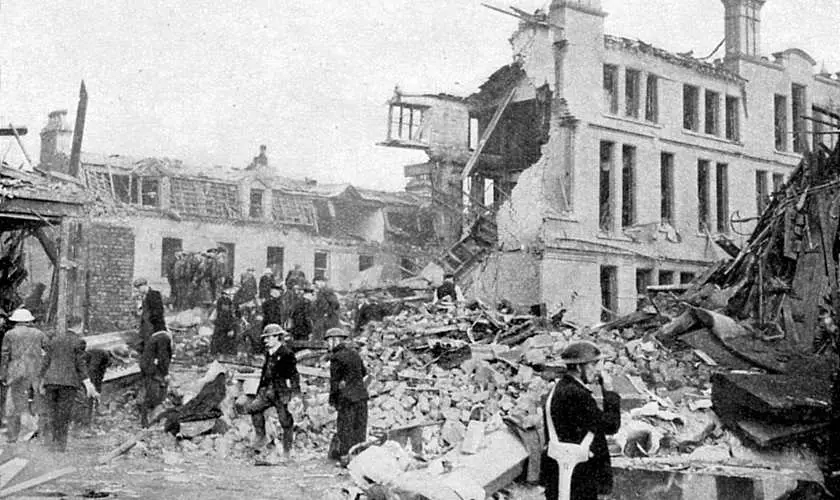 Black and white picture from World War 2 with a bombed building in the background