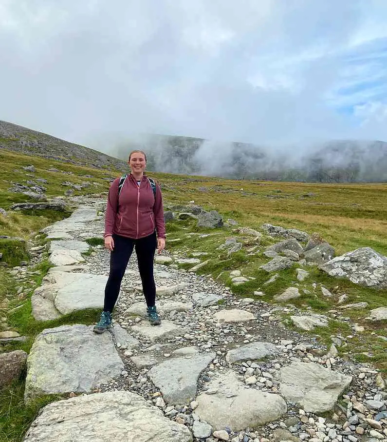 Mel stood smiling on the Llanberis route made with white stones after sunrise