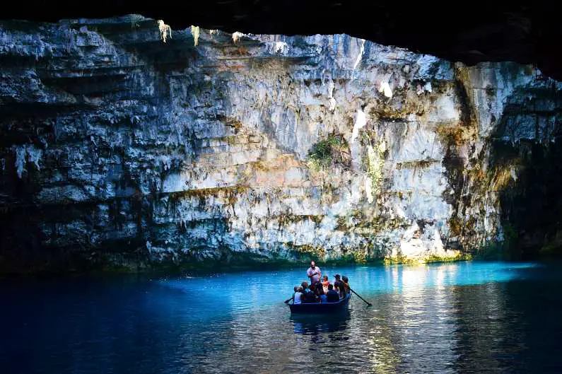 Single boat on Melissani Lake inside a cave in Kefalonia 