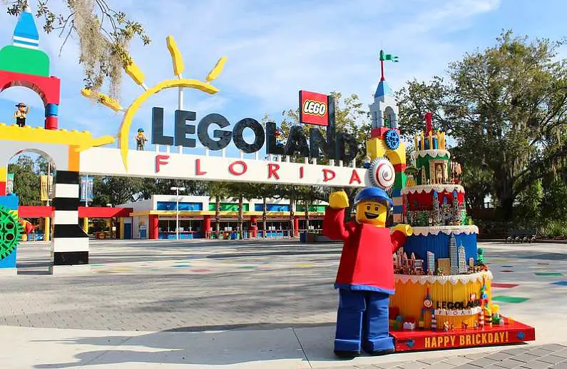 Entrance to Legoland in Florida with a Happy Brickday lego figurine and birthday cake in the foreground