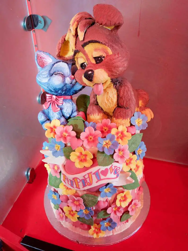 Dog and cat amongst flowers in a puppy love cake at Choccywoccydoodah