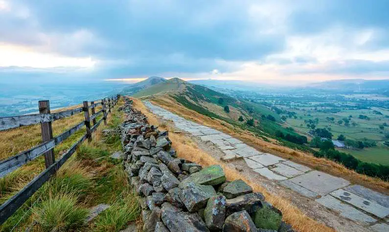 Stone path to Mam Tor with dark clouds in the background