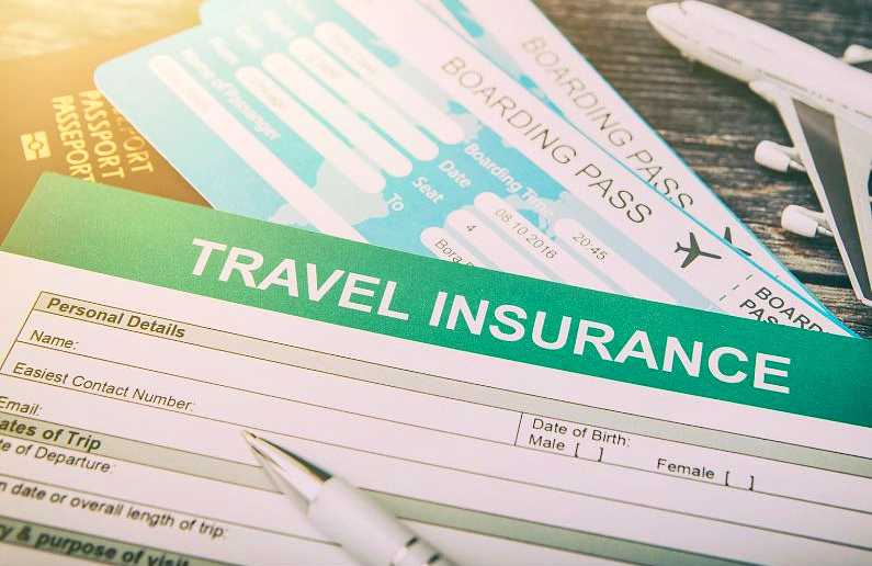 Travel insurance paperwork up close with a pen and boarding passes in the background