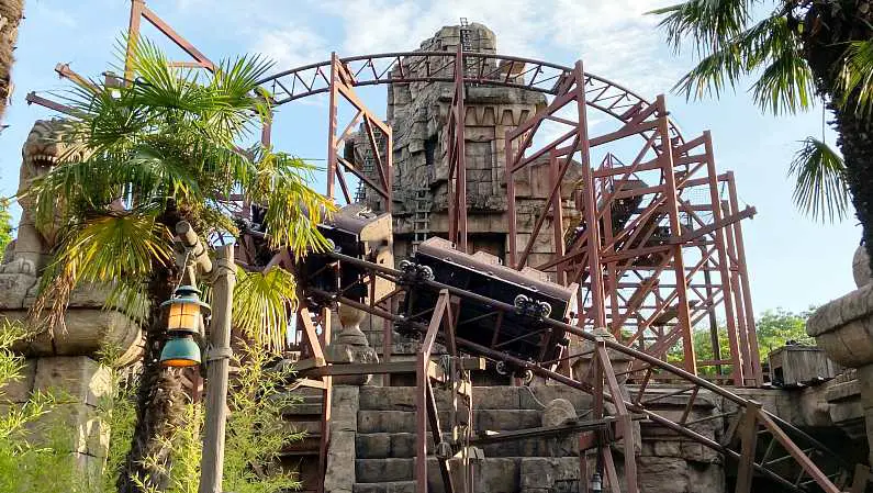 Indiana jones ride at Disneyland Paris car going over tracks above with temple in background