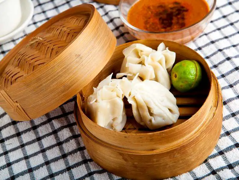Traditional Indonesian steamed sweet and savoury dumplings in a bamboo food basket 