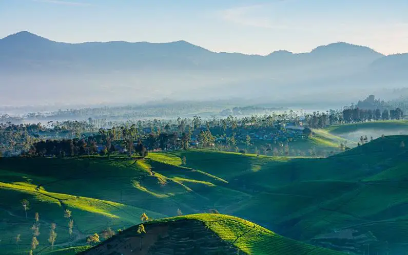 Sunrise over Pangalengan in Bandung with rolling hills in the background