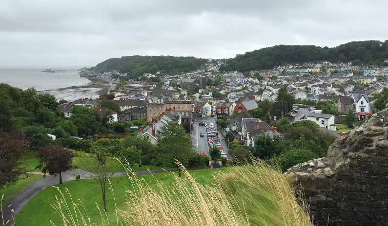 View of the bay and rows of candy-coloured houses in Swansea Bay from Oystermouth Castle