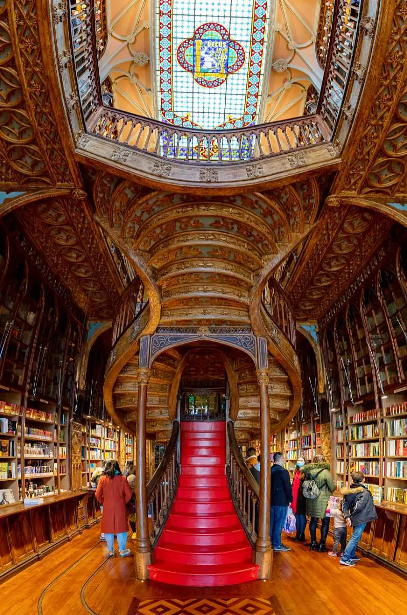 Inside Livraria Lello an ornate bookshop with a central grand staircase in Porto