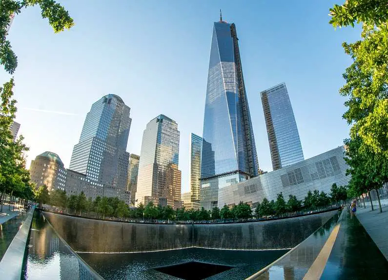 9/11 Memorial fountain with the new World Trade Center in the background
