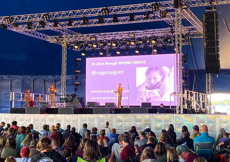 The Vegan Pig Vet on stage giving her talk with an large audience listening