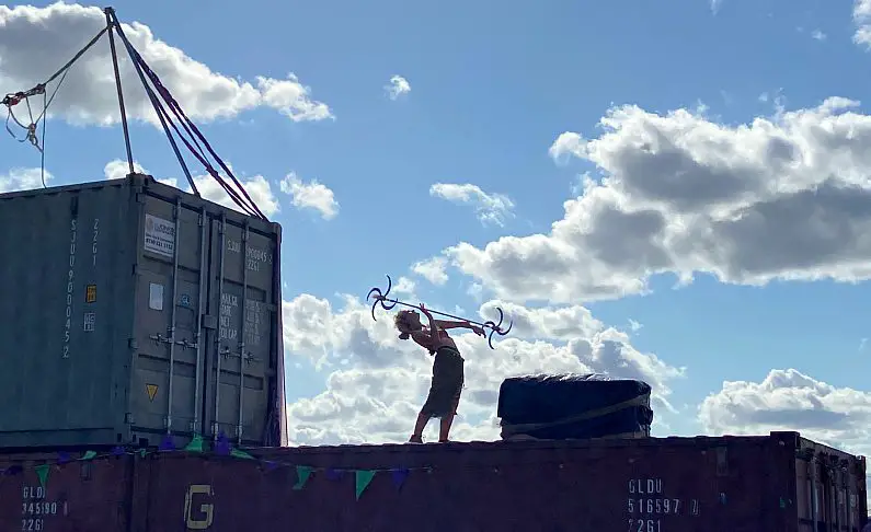 Slip Shod performer on a shipping container wall 